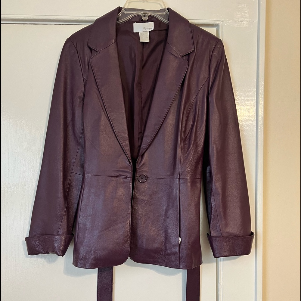 Purple leather jacket with button and belt at waist.